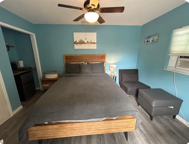 a bedroom with a bed and wooden floor