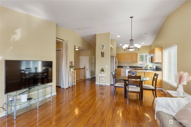 a view of a dining room with furniture wooden floor and chandelier