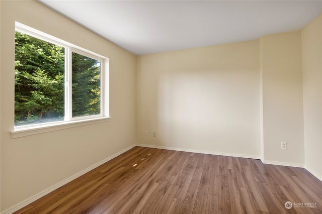 a view of a room with wooden floor and window