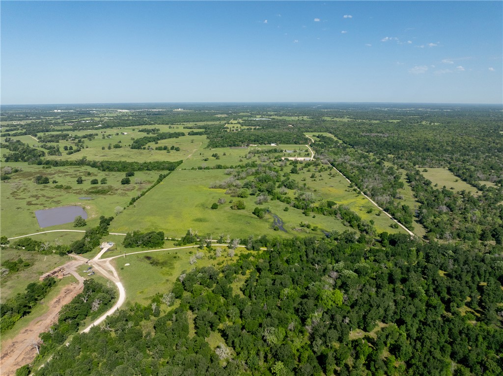 0 Clear Lake Road Bryan, TX 77808 - Photo 24 of 34 Aerial view of property and surrounding area with a forest and rural landscape