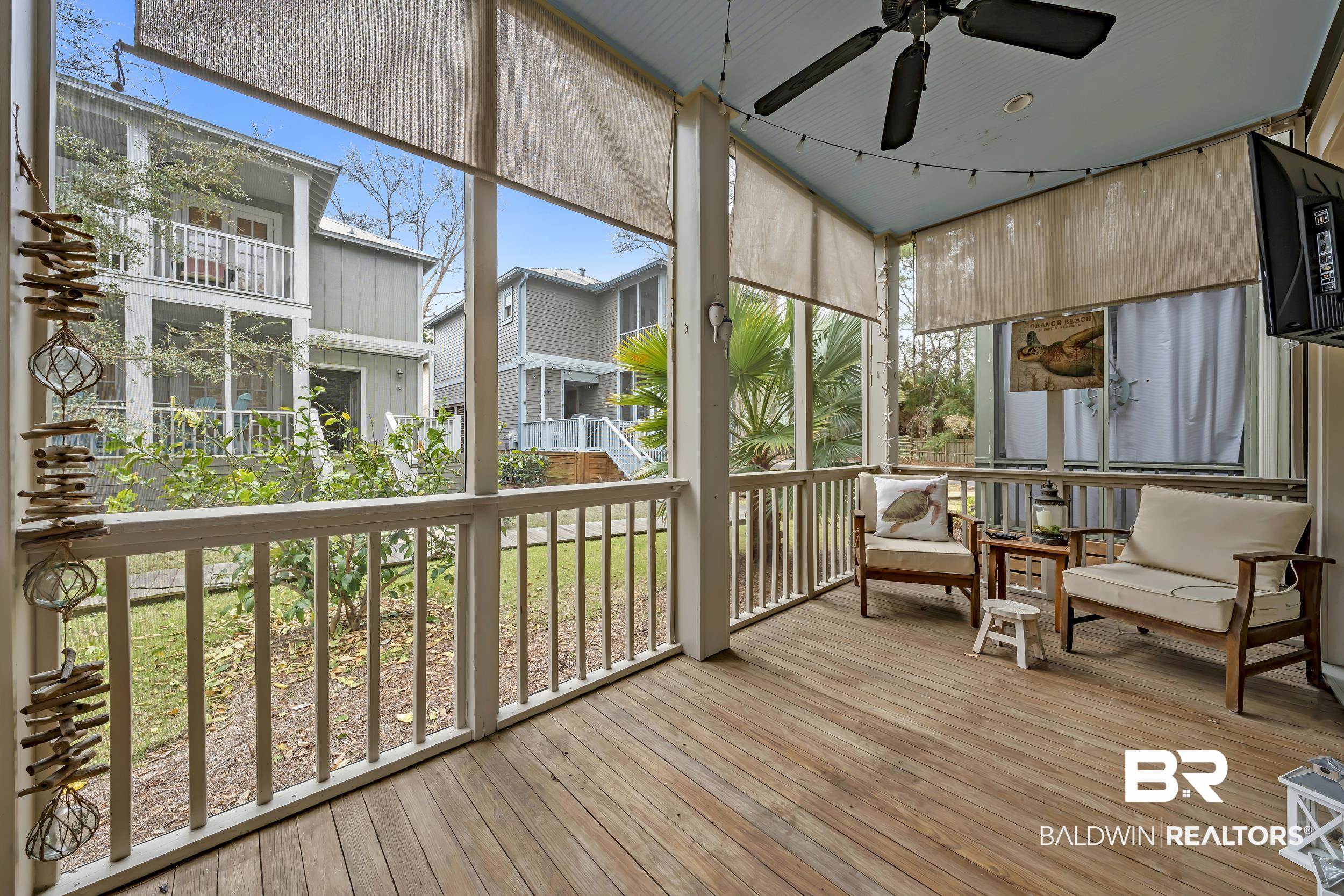 25773 Canal Road, Unit 32 Orange Beach, AL 36561 - Photo 12 of 35 Sunroom featuring a deck, a ceiling fan, and plenty of natural light