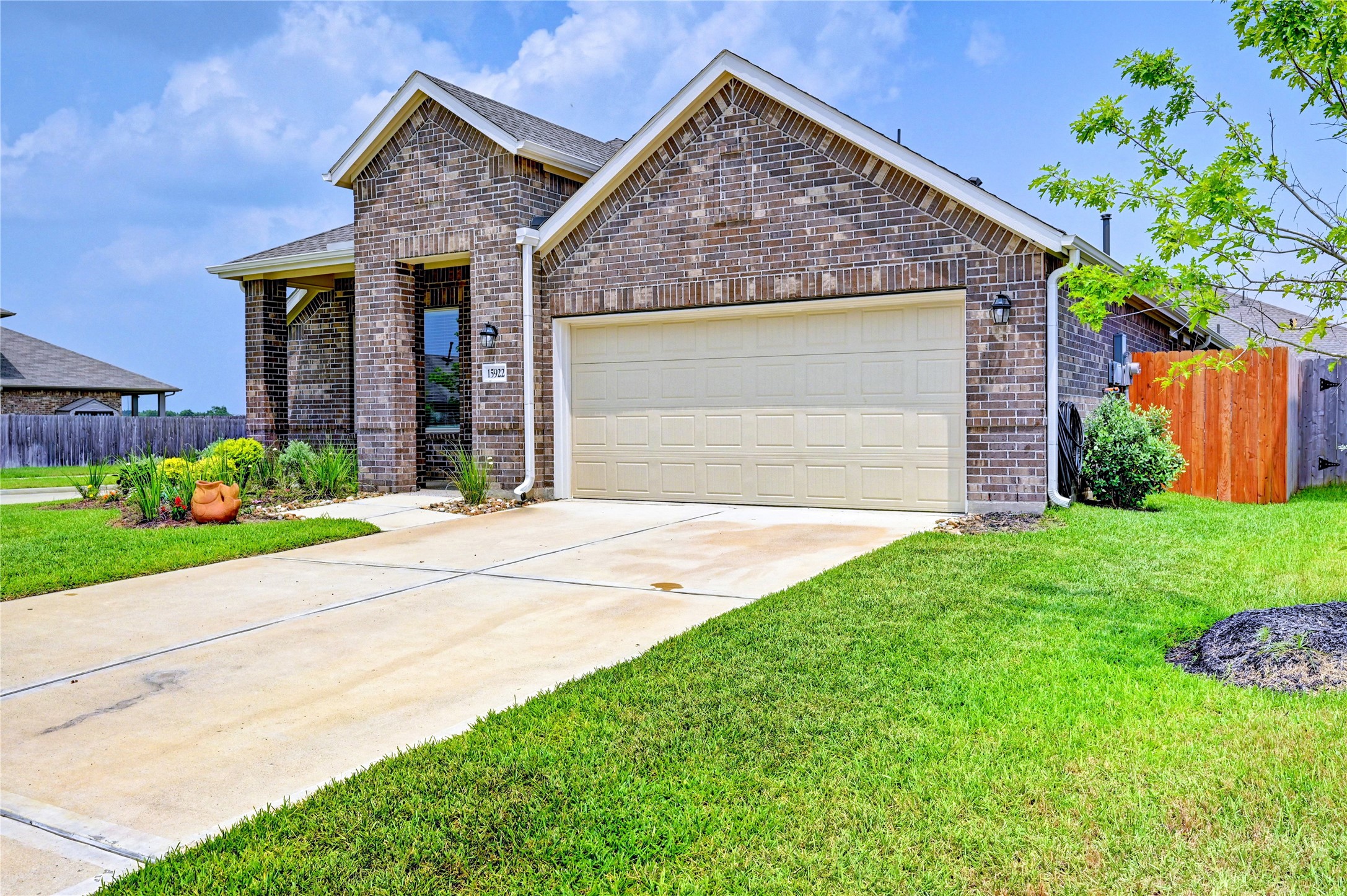 a front view of a house with a garden and plants