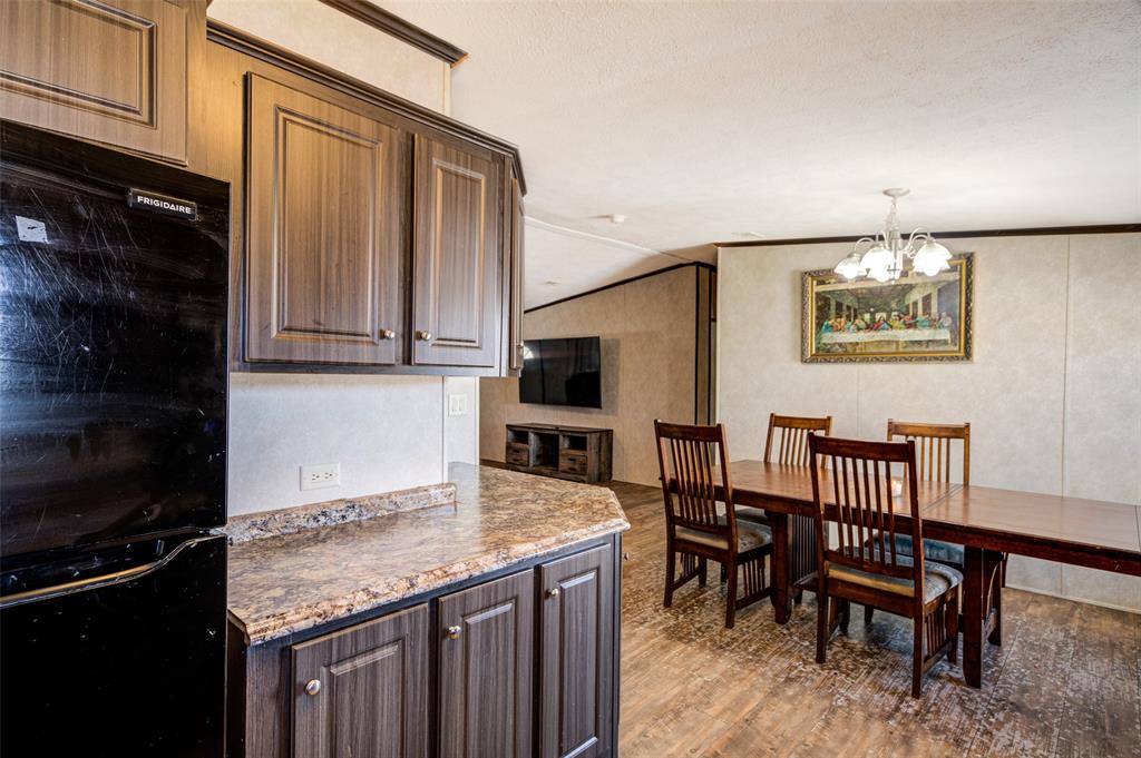1420 County Road 4522 Decatur, TX 76234 - Photo 12 of 24 a kitchen with a table chairs and a refrigerator