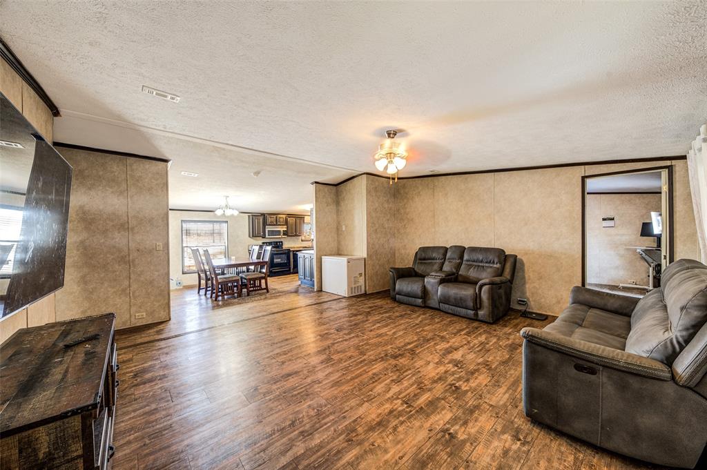 1420 County Road 4522 Decatur, TX 76234 - Photo 14 of 24 a living room with furniture and a chandelier