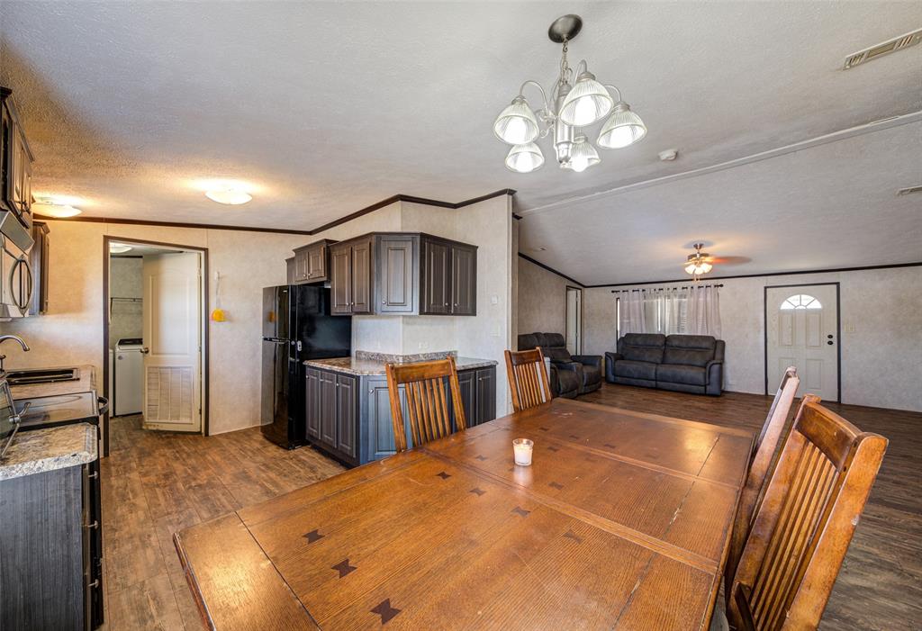 1420 County Road 4522 Decatur, TX 76234 - Photo 15 of 24 a large kitchen with stainless steel appliances wooden floor dining table and chairs