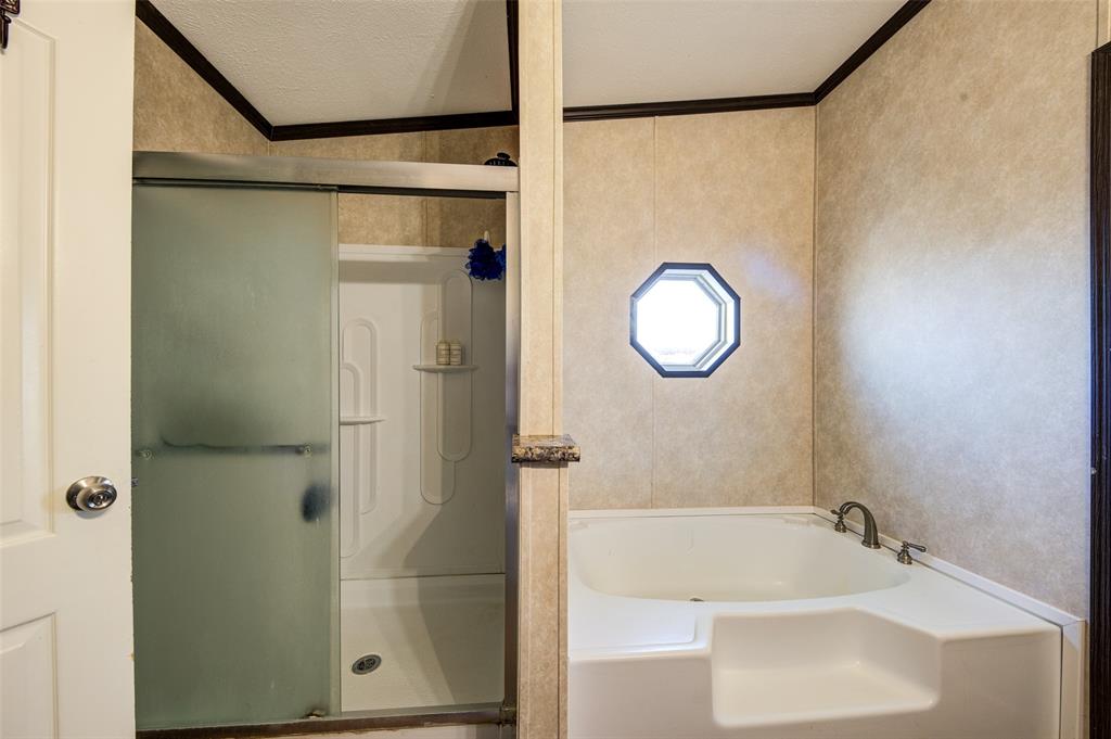 1420 County Road 4522 Decatur, TX 76234 - Photo 24 of 24 a bathroom with a tub and a shower