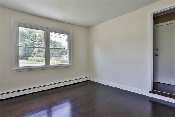 331 Pelham Street Methuen, MA 01844 - Photo 11 of 27 an empty room with wooden floor and windows