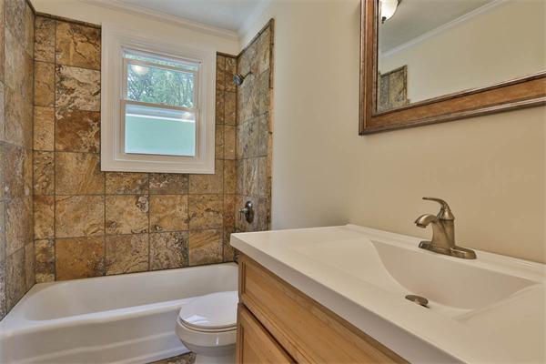 331 Pelham Street Methuen, MA 01844 - Photo 15 of 27 a bathroom with a sink a toilet and a bathtub