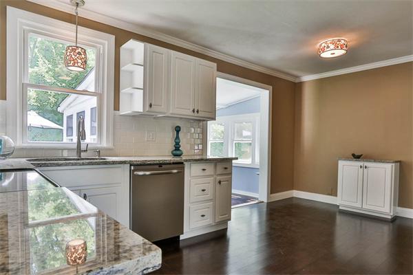 331 Pelham Street Methuen, MA 01844 - Photo 8 of 27 a kitchen with stainless steel appliances granite countertop a stove a sink and a microwave