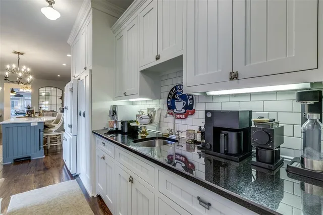 a kitchen with stainless steel appliances granite countertop a sink and cabinets