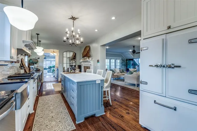 a kitchen with granite countertop a stove oven and cabinets
