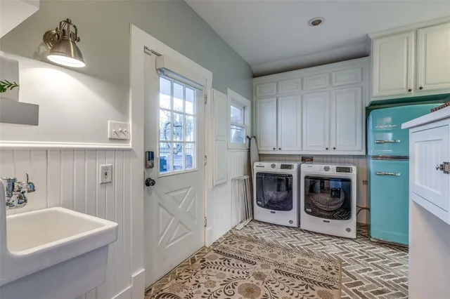 a utility room with stainless steel appliances granite countertop a washer and dryer