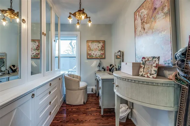 a dining room with furniture a chandelier and wooden floor