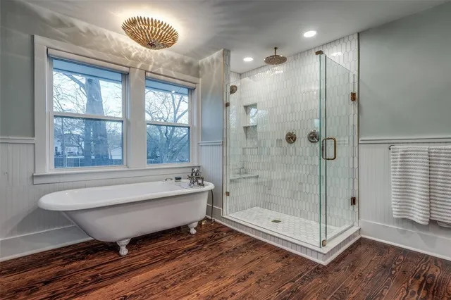 a bathroom with a bathtub and a shower