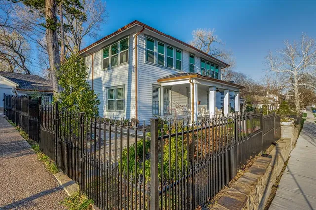 a front view of a house with wooden fence