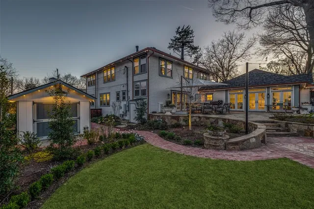 a front view of a house with a yard and outdoor seating