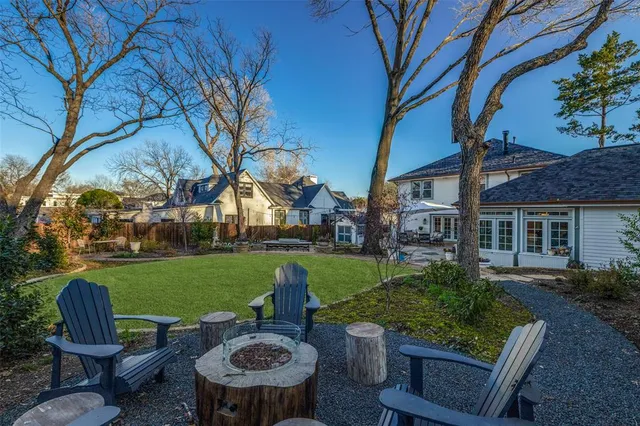 a view of a table and chairs in backyard of the house