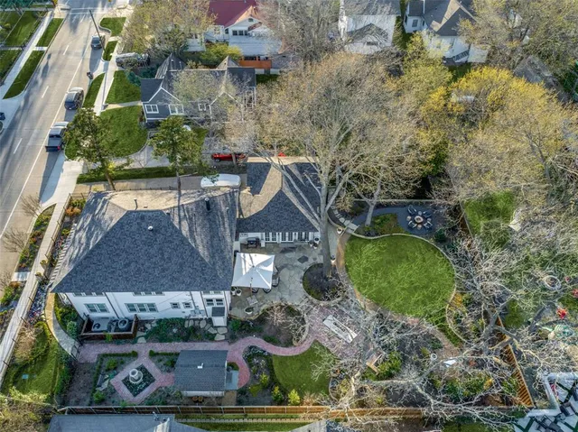 an aerial view of a house with garden space and street view