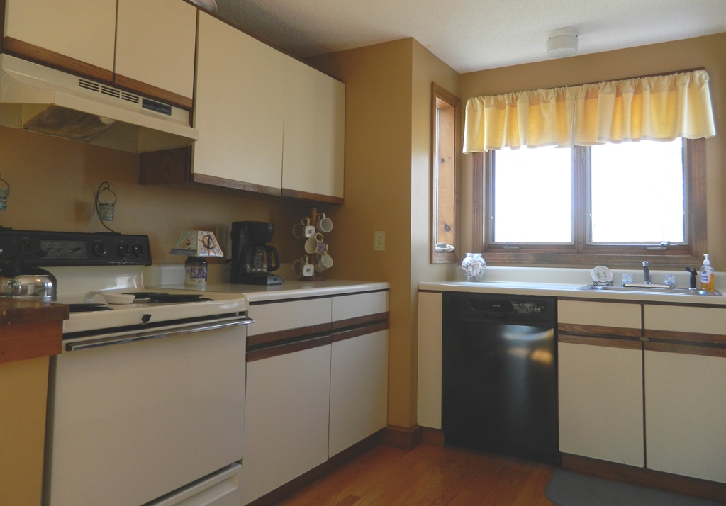 78 Old Purchase Road Edgartown, MA 02539 - Photo 3 of 17 a kitchen with stainless steel appliances granite countertop white cabinets and a window