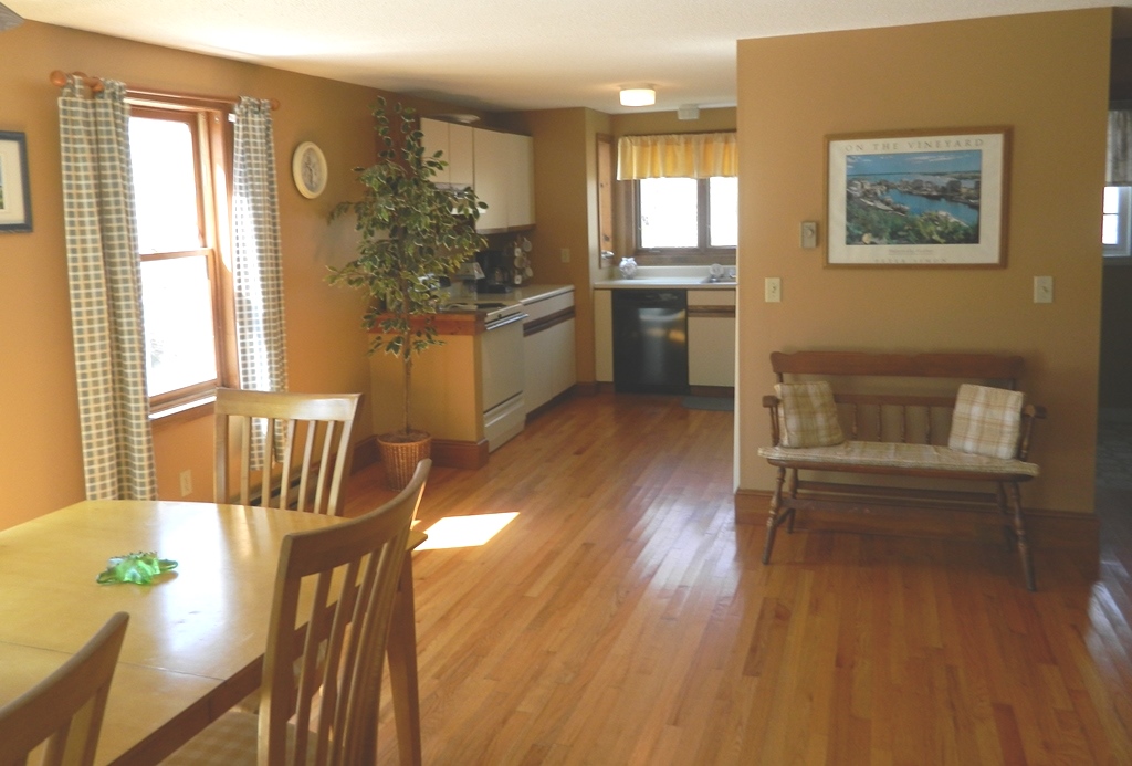 78 Old Purchase Road Edgartown, MA 02539 - Photo 8 of 17 a kitchen with a table chairs refrigerator and cabinets