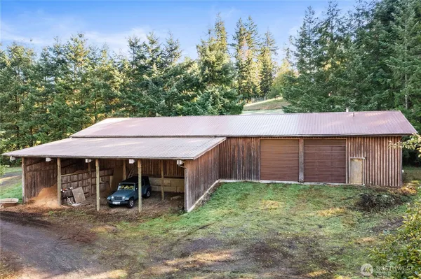a view of a house with a yard and sitting area