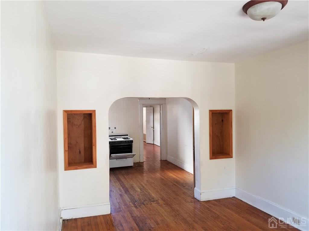 110 Rector Street Perth Amboy, NJ 08861 - Photo 5 of 15 a hallway with wooden floor and furniture