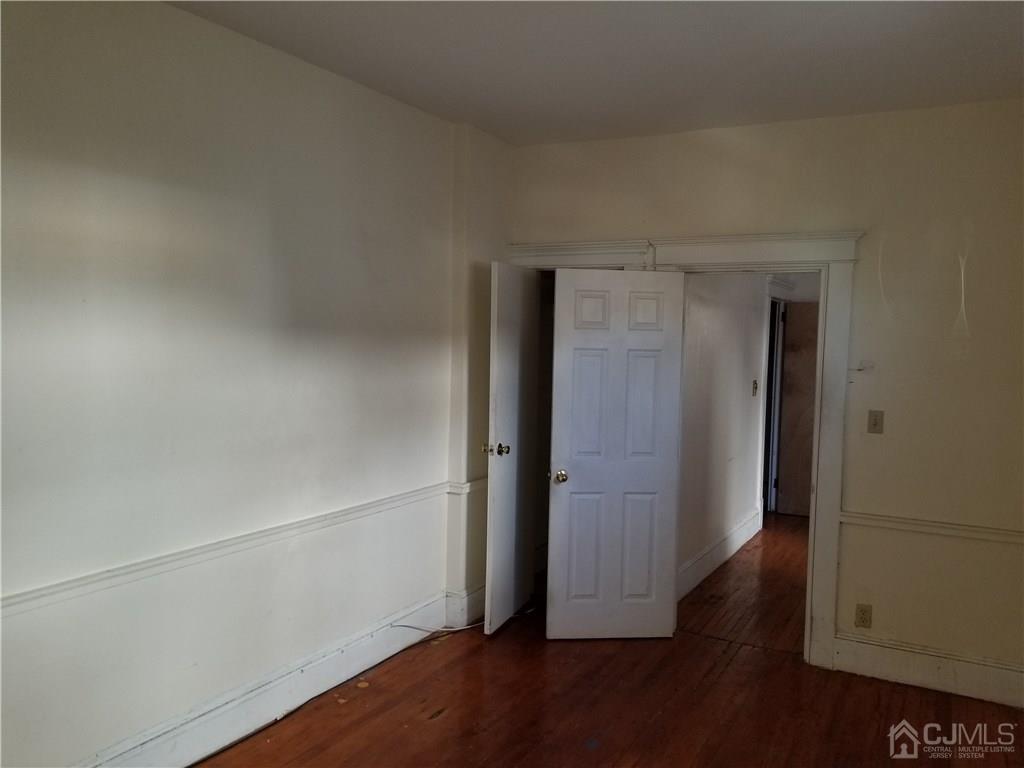 110 Rector Street Perth Amboy, NJ 08861 - Photo 9 of 15 an empty room with wooden floor