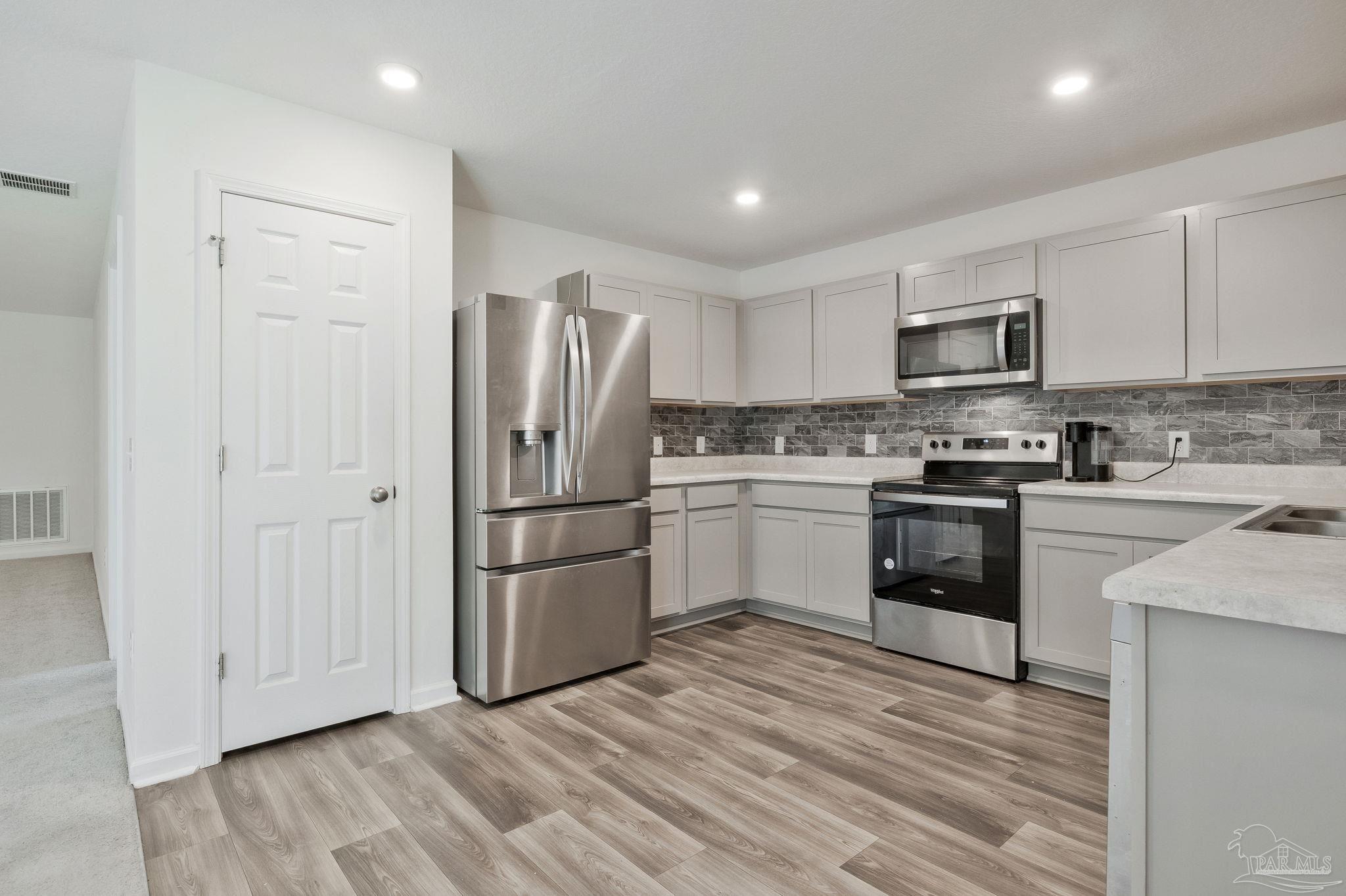 1625 Addies Way Pensacola, FL 32534 - Photo 3 of 50 a kitchen with a refrigerator stove and a sink