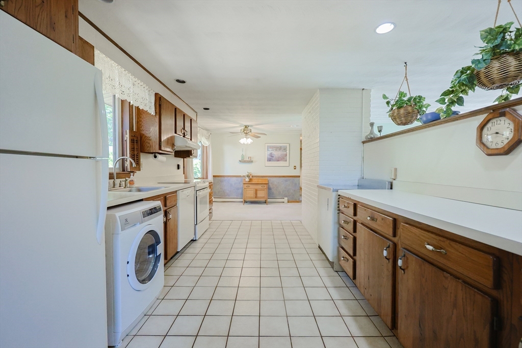 18 Paxton Road Framingham, MA 01701 - Photo 13 of 37 a utility room with cabinets washer and dryer