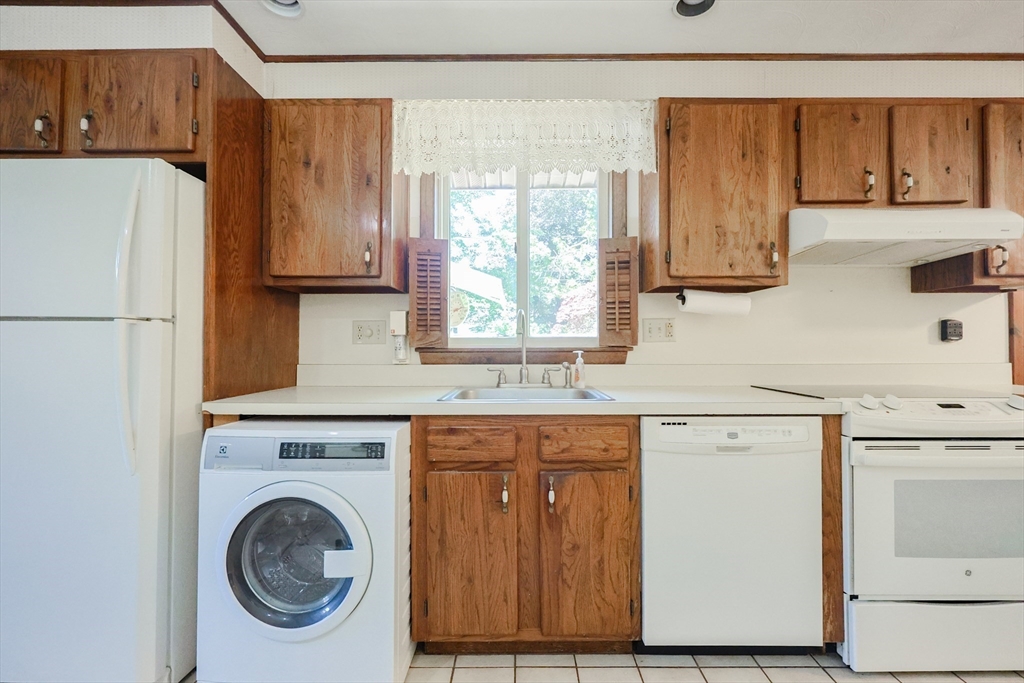18 Paxton Road Framingham, MA 01701 - Photo 15 of 37 a kitchen with a white cabinets and a refrigerator
