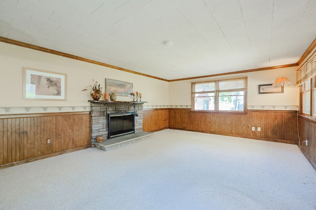 18 Paxton Road Framingham, MA 01701 - Photo 19 of 37 a view of an empty room with a fireplace and a window