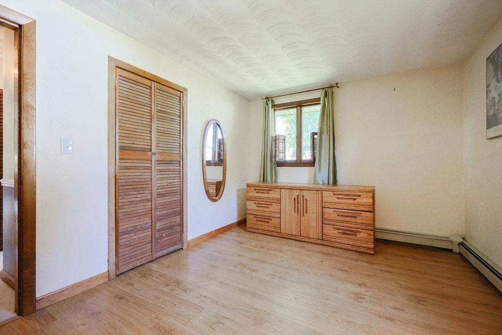 18 Paxton Road Framingham, MA 01701 - Photo 23 of 37 an empty room with windows and exposed bricks