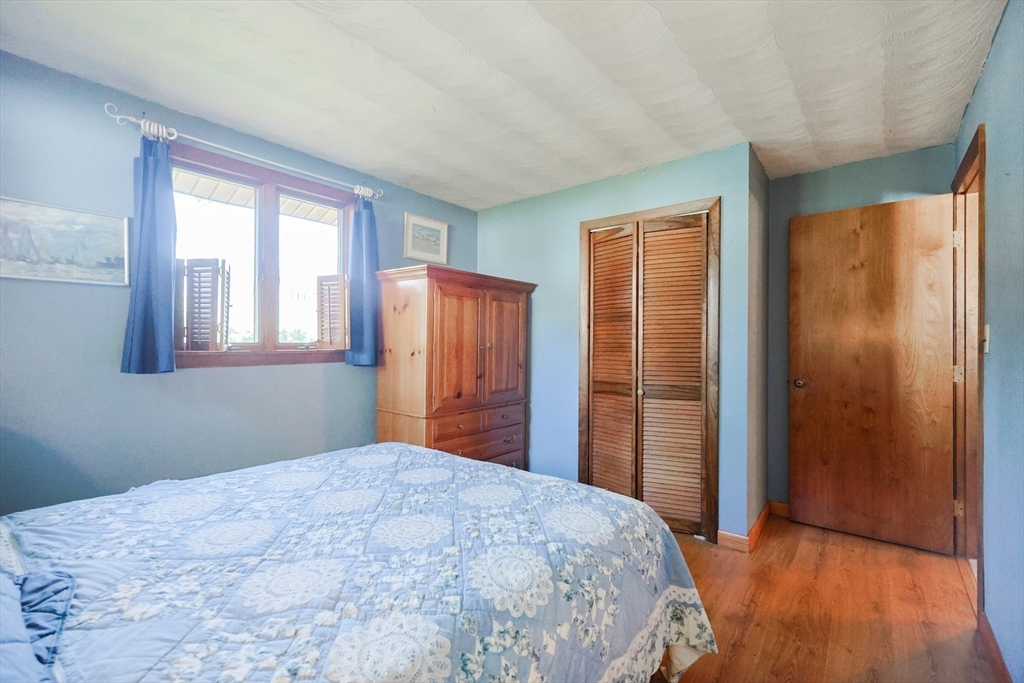 18 Paxton Road Framingham, MA 01701 - Photo 24 of 37 a bedroom with a bed and wooden floor