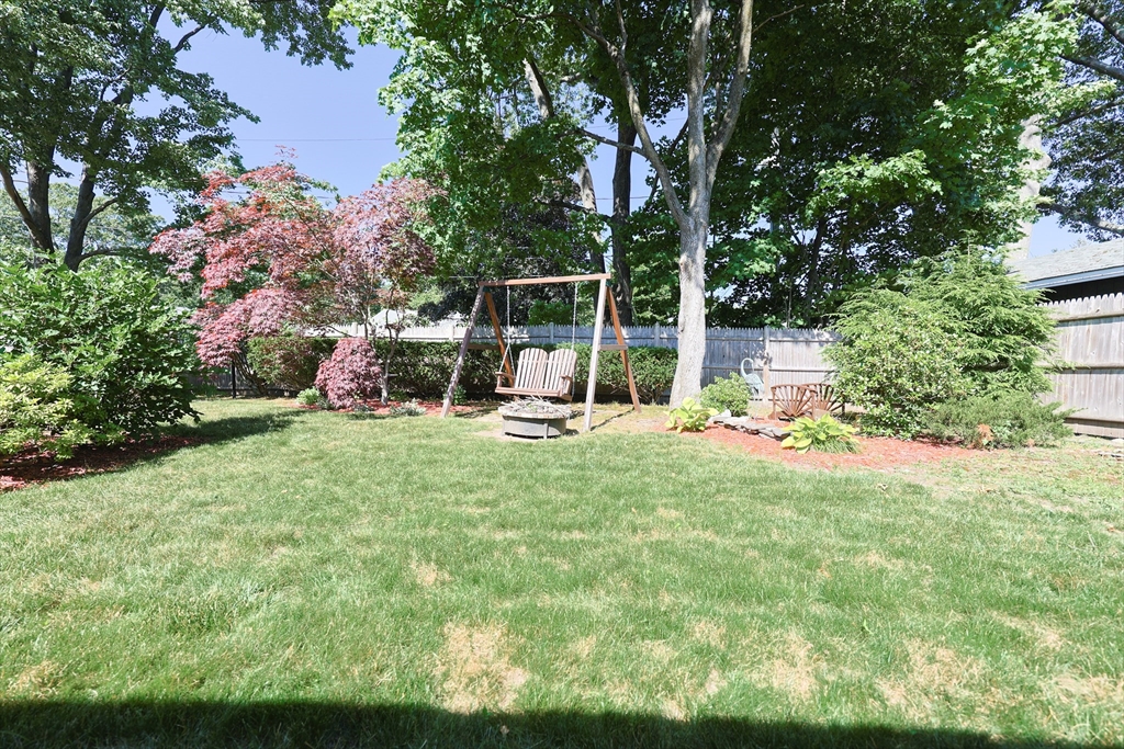 18 Paxton Road Framingham, MA 01701 - Photo 35 of 37 a view of a backyard with potted plants and large trees