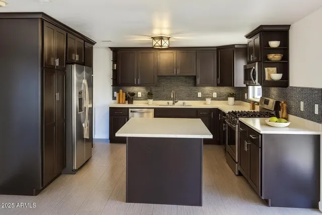 a kitchen with granite countertop a stove and a microwave