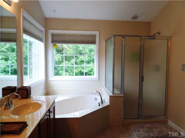 4441 Fairview Ridge Lane Apex, NC 27539 - Photo 12 of 25 Separate Shower'and whirlpool garden tub, dual Vanity and tile floor, large windows to enjoy the wooded backyard Master Bath/Spa