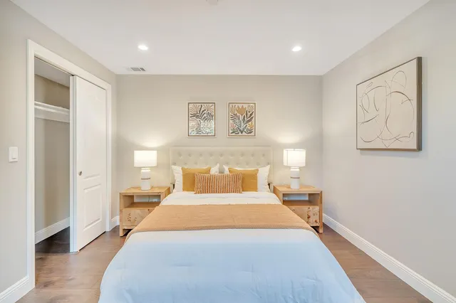 a bedroom with a large bed and a window