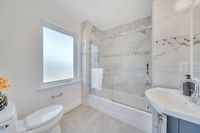 a view of a balcony with two chairs and a table