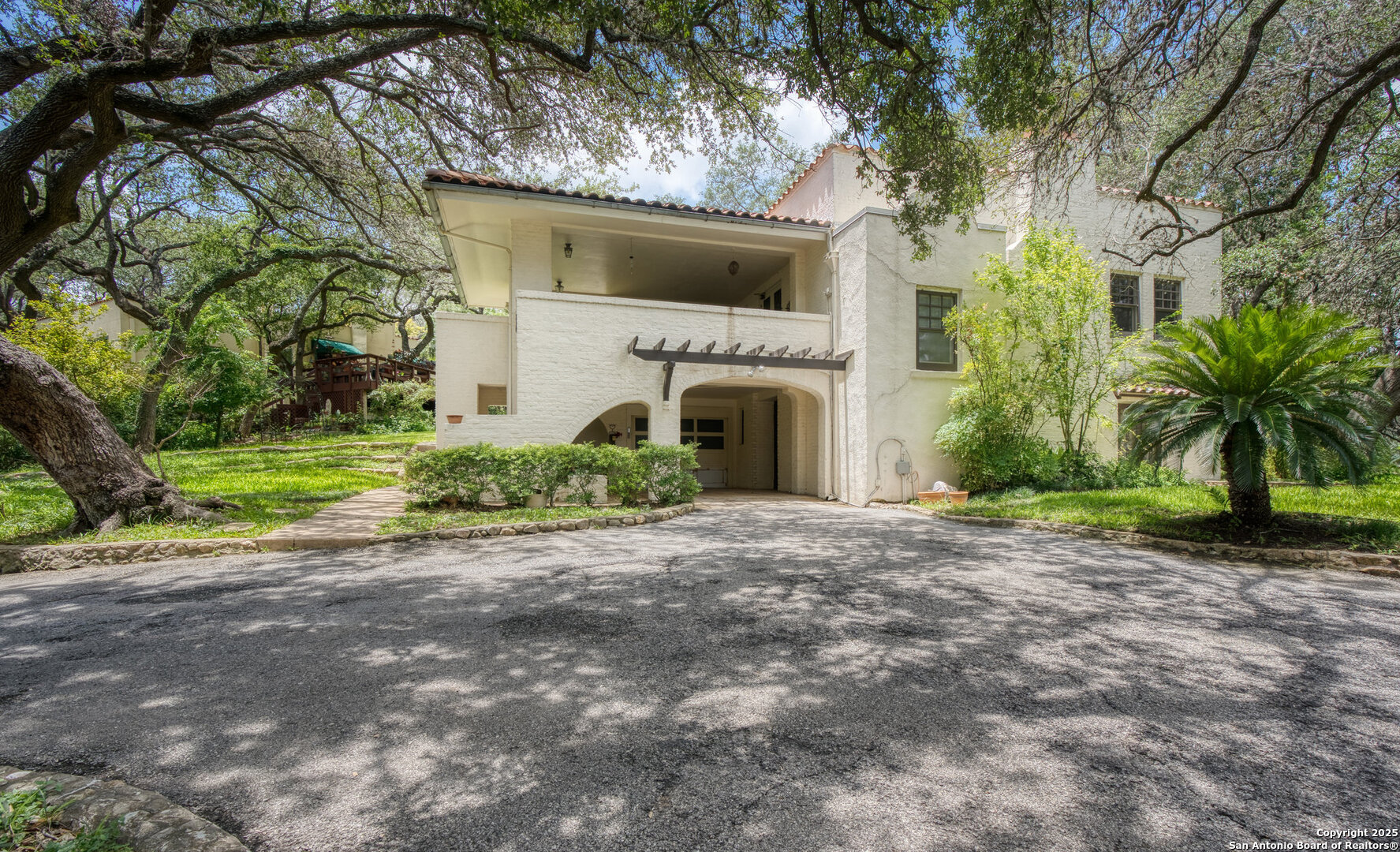 5351 Fredericksburg Road San Antonio, TX 78229 - Photo 1 of 50 a front view of a house with a yard and garage