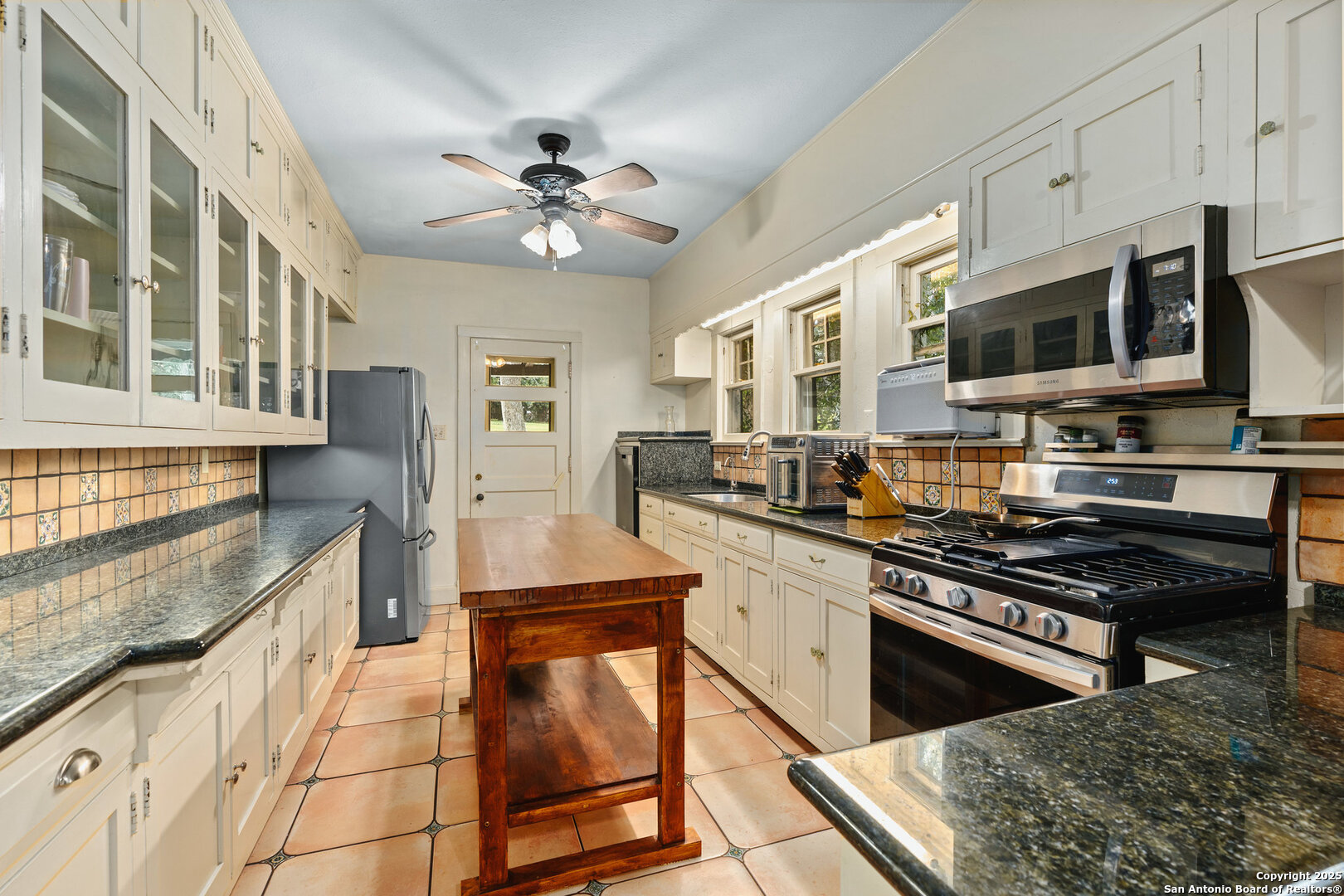 5351 Fredericksburg Road San Antonio, TX 78229 - Photo 20 of 50 a kitchen with stainless steel appliances granite countertop a stove a sink and a microwave