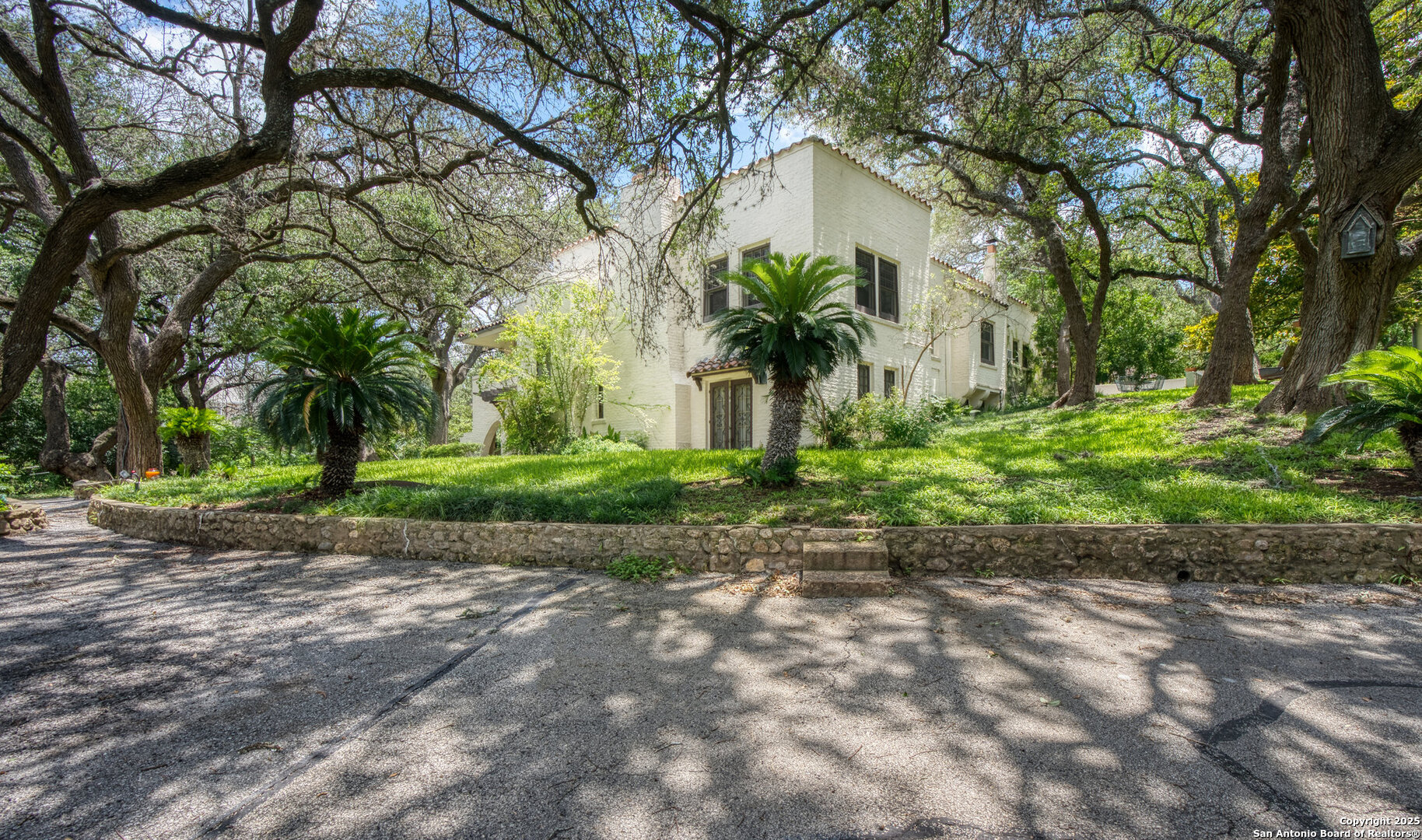 5351 Fredericksburg Road San Antonio, TX 78229 - Photo 40 of 50 a front view of a house with a yard and a garden