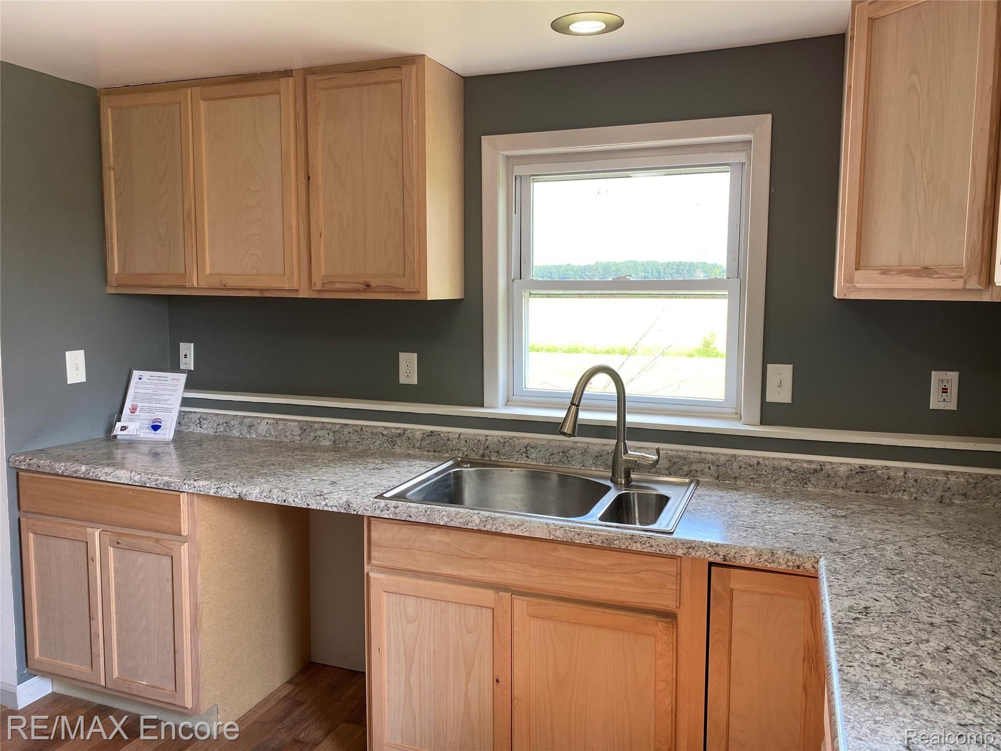 7740 Cram Road Owosso, MI 48867 - Photo 9 of 30 New countertops, new cabinets, and new flooring.