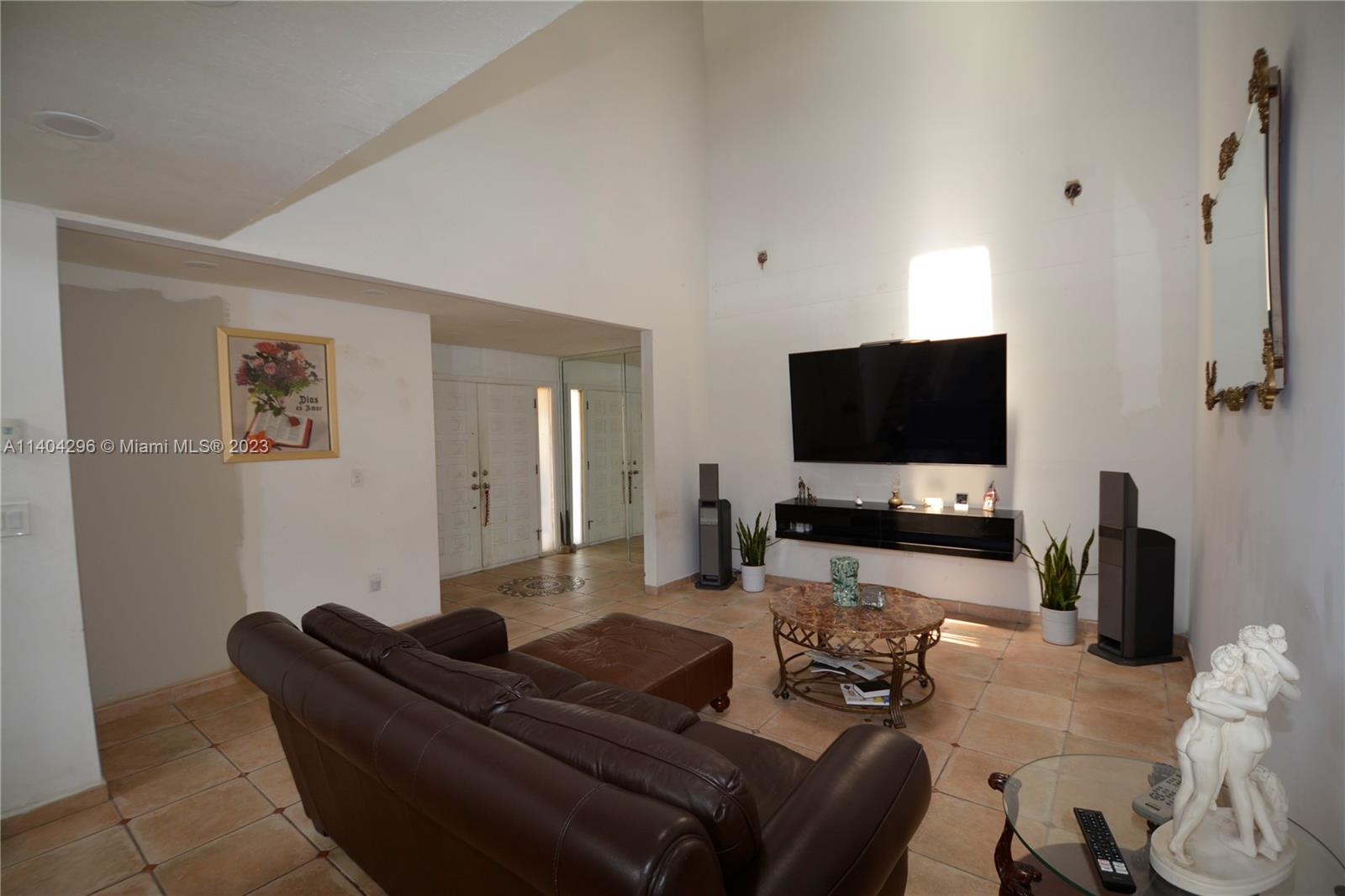 10915 Southwest 25th Street, Unit 2 Miami, FL 33165 - Photo 1 of 28 a living room with furniture and a flat screen tv