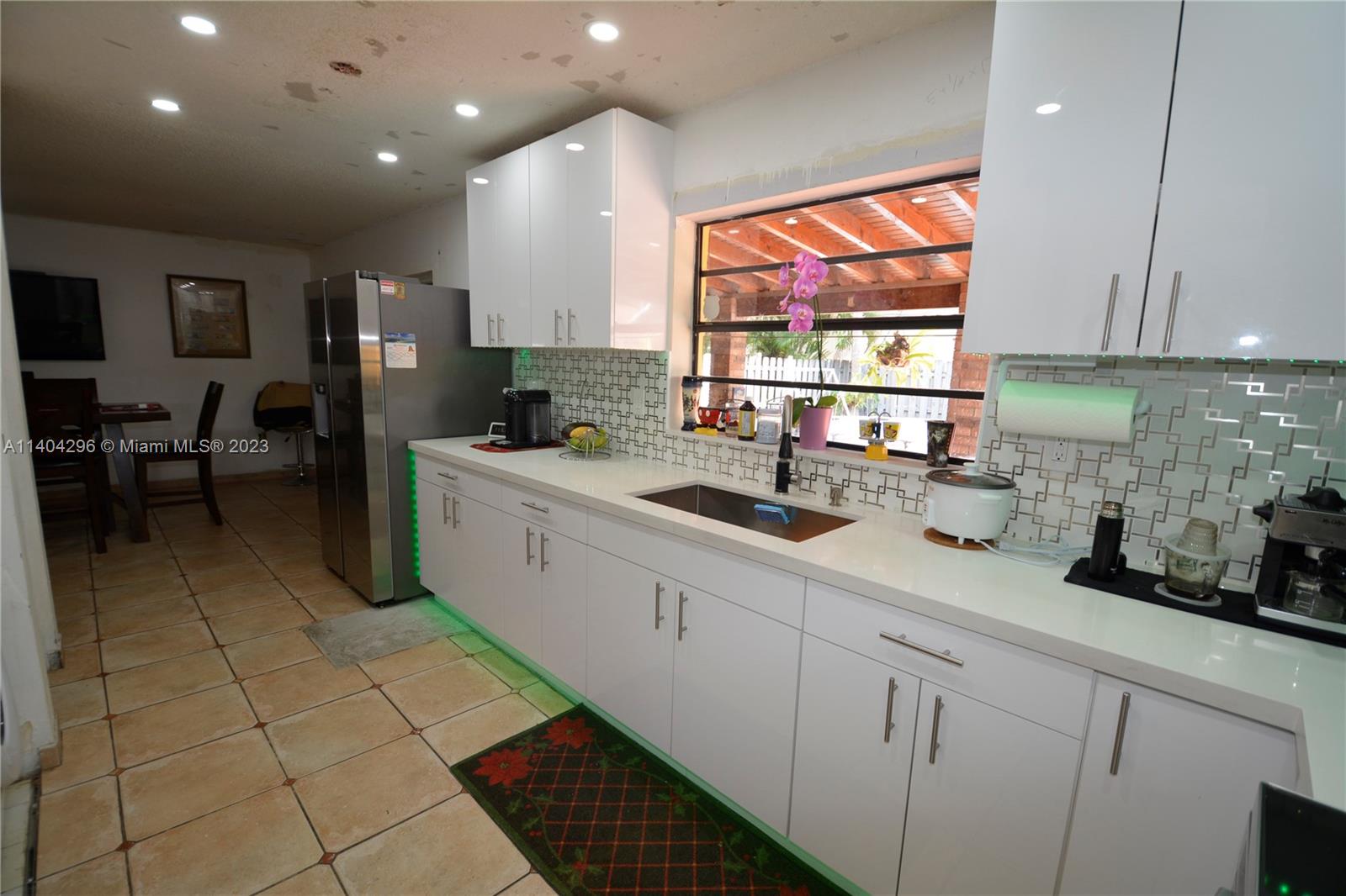 10915 Southwest 25th Street, Unit 2 Miami, FL 33165 - Photo 11 of 28 a kitchen with stainless steel appliances a sink stove and cabinets
