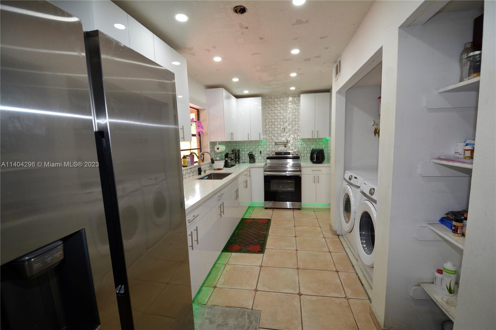 10915 Southwest 25th Street, Unit 2 Miami, FL 33165 - Photo 12 of 28 a kitchen with stainless steel appliances granite countertop a refrigerator a stove and a sink