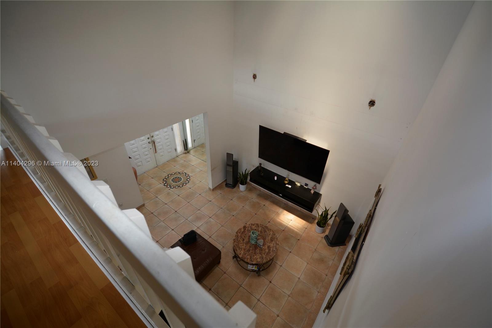 10915 Southwest 25th Street, Unit 2 Miami, FL 33165 - Photo 18 of 28 a living room with furniture and a flat screen tv