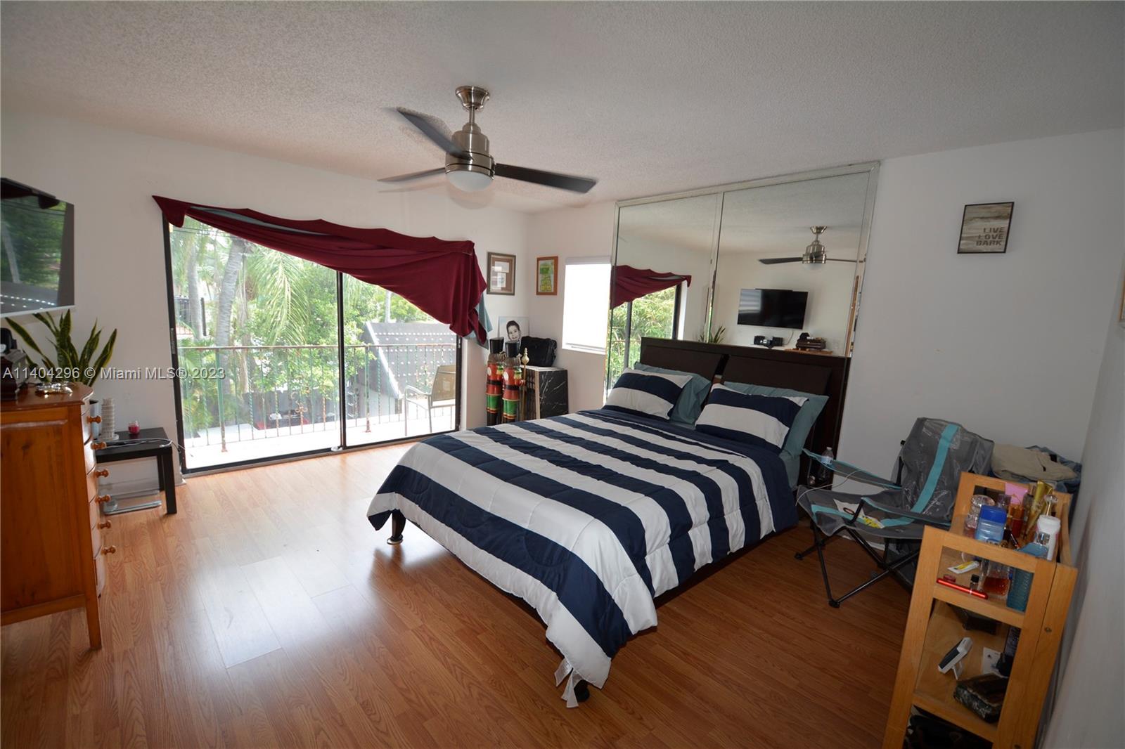 10915 Southwest 25th Street, Unit 2 Miami, FL 33165 - Photo 20 of 28 a bedroom with a bed and wooden floor