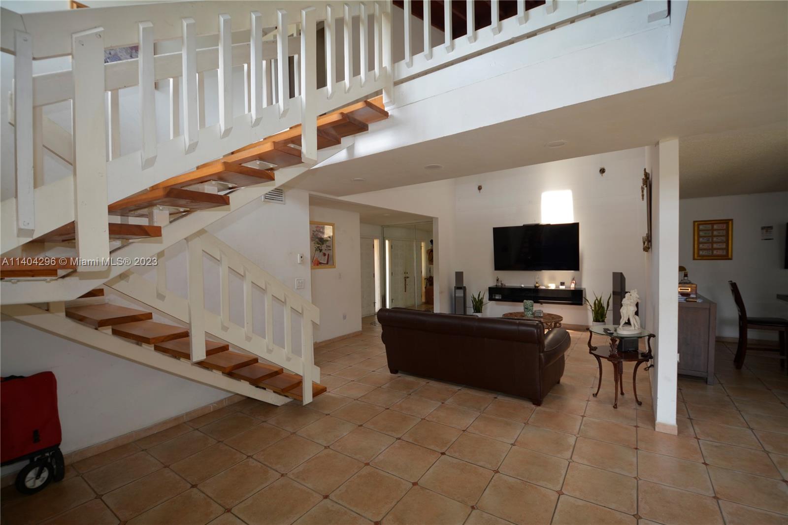 10915 Southwest 25th Street, Unit 2 Miami, FL 33165 - Photo 2 of 28 a living room with furniture and a flat screen tv