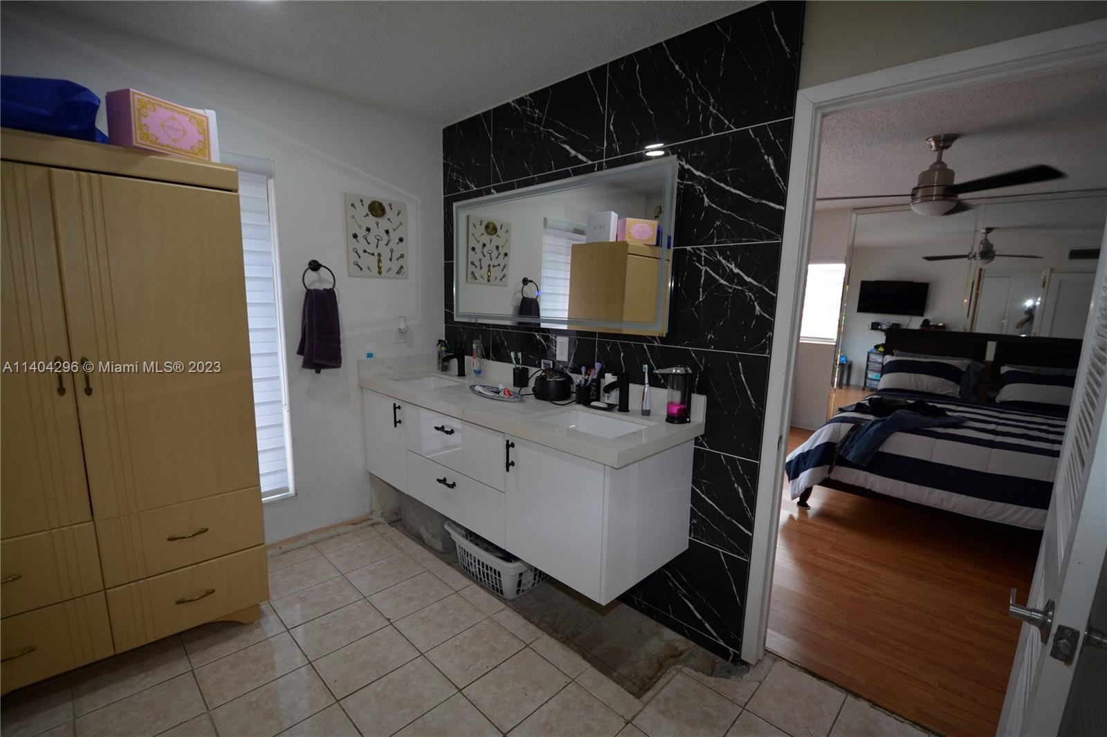 10915 Southwest 25th Street, Unit 2 Miami, FL 33165 - Photo 22 of 28 a bathroom with a mirror and a shower