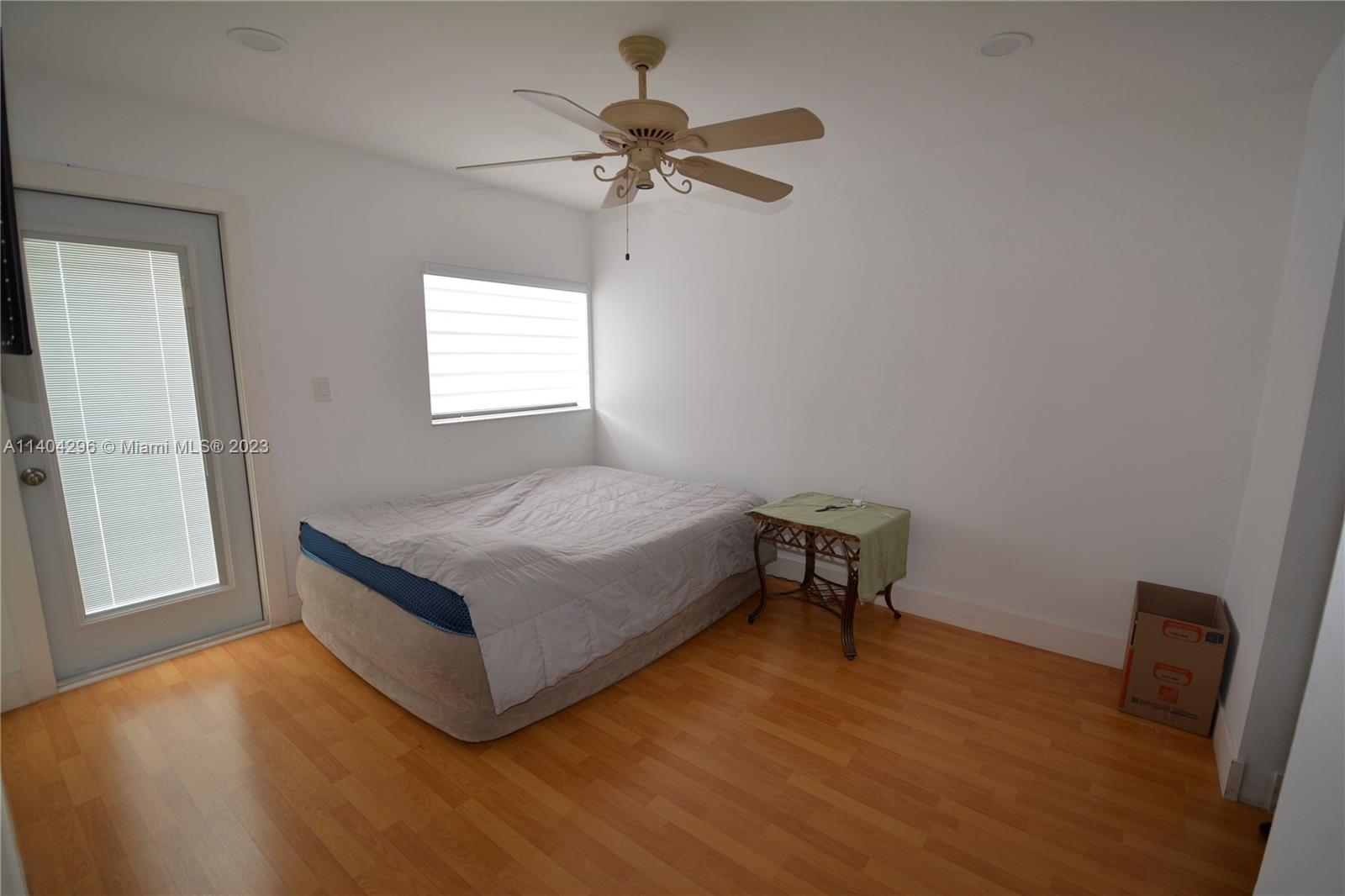 10915 Southwest 25th Street, Unit 2 Miami, FL 33165 - Photo 23 of 28 a bedroom with a bed and a table in it